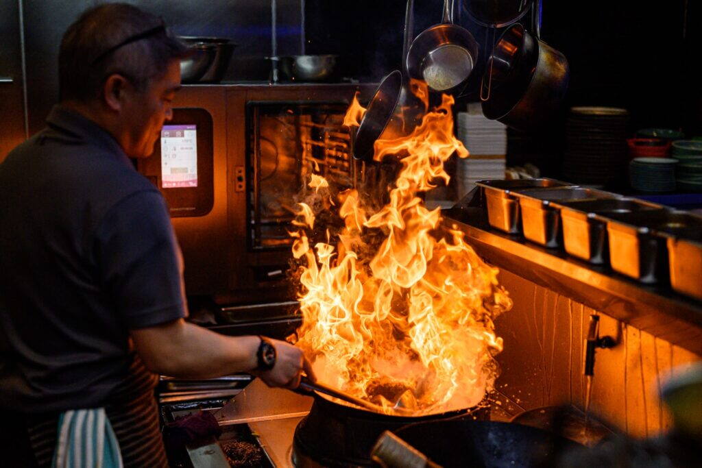 Chef tossing a flaming wok