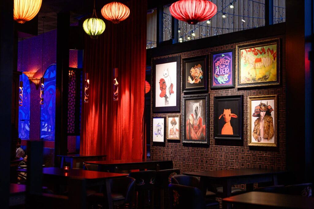 Dining room with gallery wall and red curtains