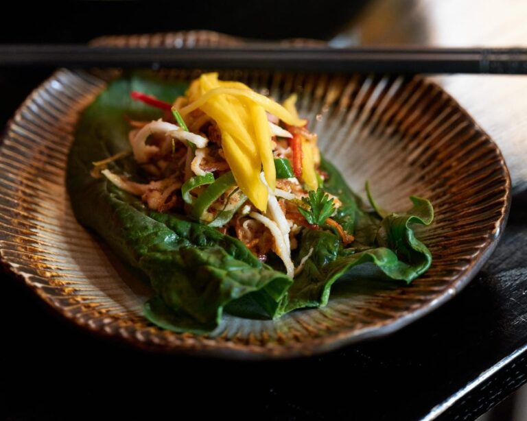 Chef's famous spinach leaf topped with green mango, chilli and peanuts at Zodiac